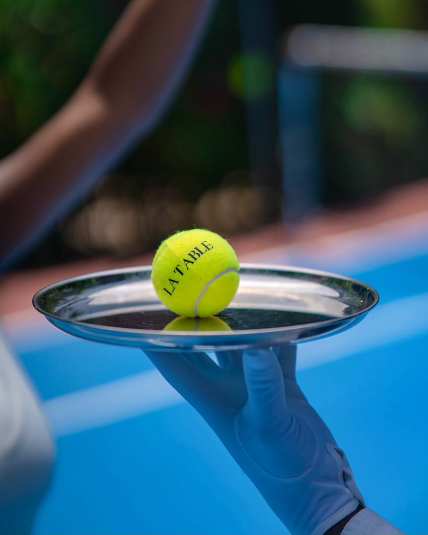 A LA TABLE tennis ball presented on a silver tray